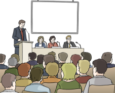 Ein Mann hält einen Vortrag auf einer Tagung vor vielen Menschen.